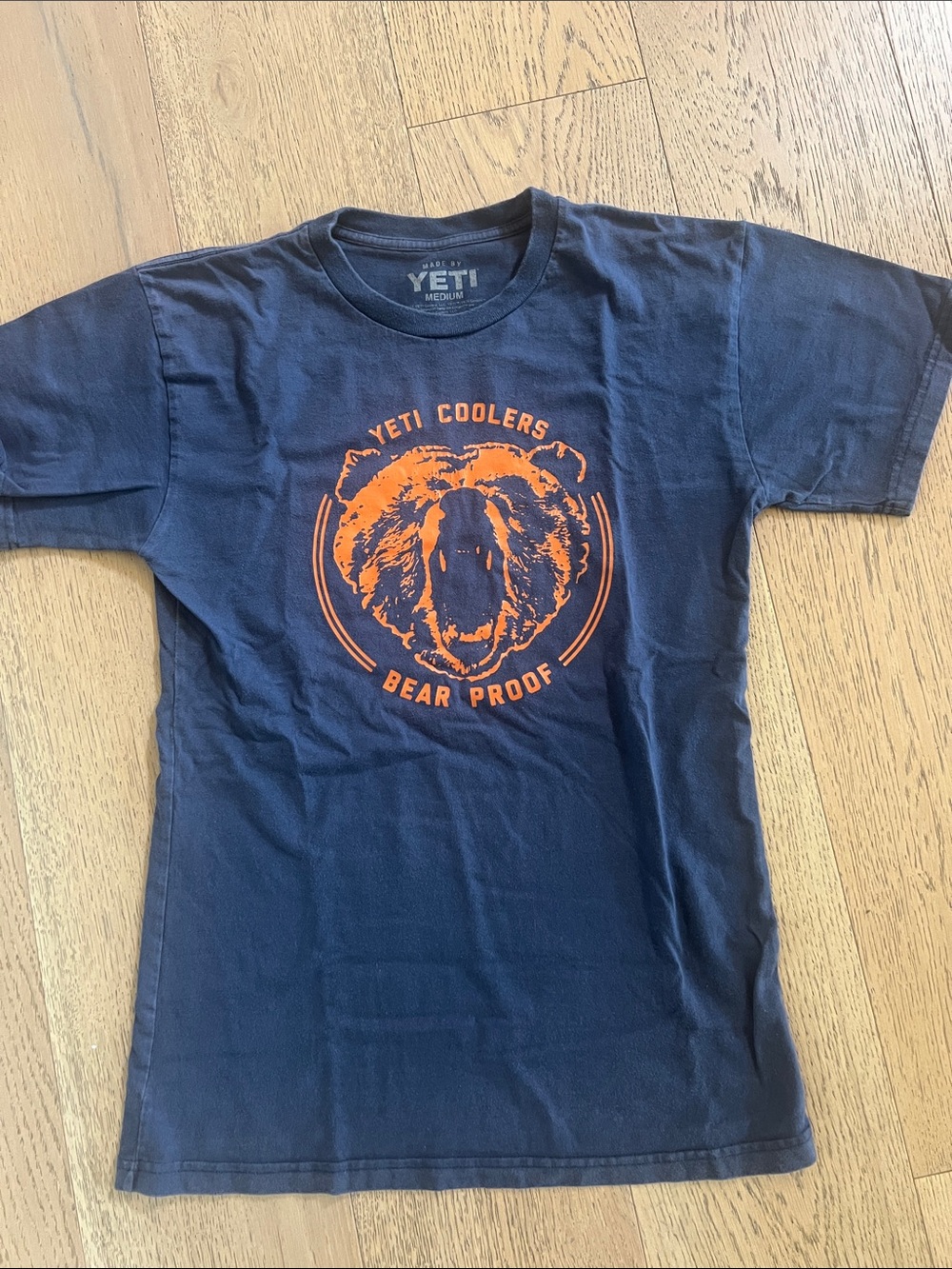 Yeti Navy Tee with Orange Bear Logo. Size medium.